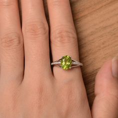 It is a natural peridot ring. The main stone is 7mm*9mm oval cut, weight about 1.99 carats. The basic metal is sterling silver and plated with rhodium. To change the metal to a solid gold (white/rose) or platinum is also available, please ask for a quotation if you want. You can also go to my shop Home for more elegant rings: https://www.etsy.com/shop/godjewelry?ref=hdr_shop_menu More rings: https://www.etsy.com/shop/godjewelry?ref=l2-shop-header-avatar Customization is always welcome and please Oval Peridot Silver Jewelry, Silver Oval Peridot Jewelry, Silver Peridot Oval Jewelry, Oval Peridot Green Jewelry, Oval Green Peridot Jewelry, Lime Green Oval Jewelry For May Birthstone, Green Oval Peridot Jewelry, Oval Peridot Ring In White Gold, Oval Peridot Solitaire Jewelry