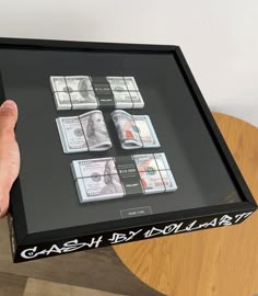 a person holding up a box with money in it and the words cash by individual written on it