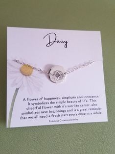 a card with a daisies charm on it