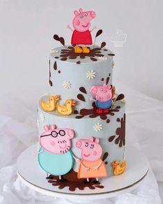 a three tiered cake decorated with pepo and friends