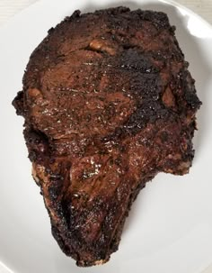 a piece of steak on a white plate