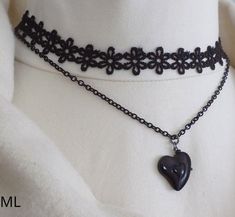 Two strand choker necklace, featuring black lace and recycled black coated chain with a black ceramic heart pendant. Perfect for festive season celebrations. Measurements lace collar - approx 37 cms chain- approx. 43 cms heart pendant - 2 X 2 cm The necklace is adjustable, extension chain is attached. Will be sent in a box as seen in the photo. Shipping All items will be sent by Royal Mail Standard /Hermes (domestic) and Royal Mail International Standard to other destinations. Please note! Royal Elegant Black Heart Pendant Choker, Black Heart-shaped Emo Choker, Elegant Black Heart-shaped Choker, Black Heart Pendant Choker, Black Choker For Valentine's Day Gift, Valentine's Day Gift Black Choker, Vintage Black Necklace For Valentine's Day, Black Emo Choker Necklace, Emo Black Choker Necklace