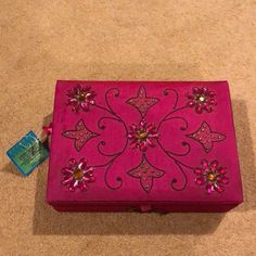 a pink box sitting on top of a carpet covered floor