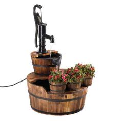 an old fashioned water pump with flowers growing out of it