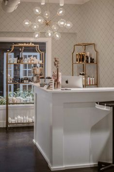 a white counter top sitting under a chandelier