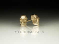 Realistic and anatomically correct skull earrings in solid 14K yellow, white or rose gold. Intricately hand carved, these skull studs make the perfect creepy and spooky unisex gift for men & women; birthday, Halloween, medical student graduation or gift for self! * One pair skull stud earrings, handmade in 14K yellow, white or rose gold. * Approximately 7.5mm high by 4.7mm across. * Polished or matte finish available. * Solid 14K posts and friction backs. Please allow us 1-2 weeks to make your e Realistic Anatomy, Anatomy Jewelry, Metal Skull Single Earring, Bronze Skull-shaped Jewelry Gift, Skull-shaped Metal Earrings, Gold Skull-shaped Earrings, Black Skull-shaped Earrings With Skull Print, 3d Skull, Gold Skull