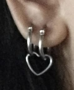 an earring with a heart hanging from it