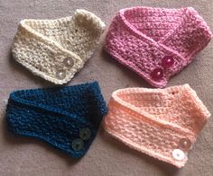 three crocheted baby hats with buttons on them