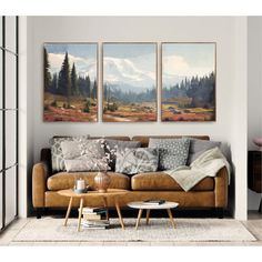 a living room scene with two paintings on the wall and a coffee table in front of it