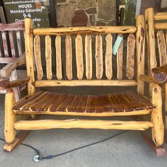 a wooden bench sitting on top of a sidewalk