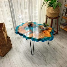 a table that has some plants on top of it in the middle of a room