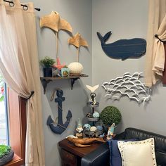 a living room filled with lots of furniture and wall decorations on top of it's walls