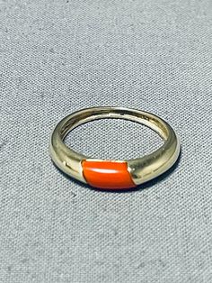 MAKE US AN OFFER BY CLICKING THE "MESSAGE SELLER" Button- This is a striking vintage Navajo inlaid gold ring. This remarkable ring contains solid 14k gold with an amazing inlaid coral stone in the center. The simplicity of this ring is just incredible.  The ring face measures around 3/4" x 1/8". Signed by Navajo artist, L. The ring size is around 5.5. Cir. 1990's+. 14k gold. Sturdy 2 grams.  Make Us an Offer- Due to the high demand of our items, many pieces sell quite fast. The most frequent ema Vintage Gold Turquoise Ring, Retro 14k Stamped Round Jewelry, Retro Yellow Gold Round Rings, Retro Yellow Gold Ring Jewelry, Retro Yellow Gold Ring, Vintage Enamel Ring With Polished Finish, Retro Red Ring Jewelry, Vintage Orange Rings For Collectors, Vintage Polished Enamel Ring