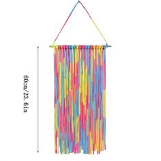 a rainbow colored wall hanging decoration with fringes on it's side and measurements