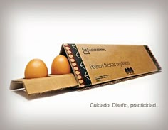 two eggs in a cardboard box with the words, cuidado diseno practical