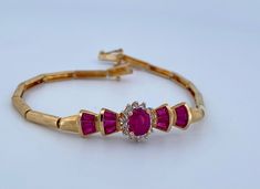 "Welcome To Gold Knox Beautiful and elegant  vintage 14k yellow gold bracelet with rubies and diamonds Great details and perfect gift idea for engagement or wedding Details Below; Material               14k yellow gold, red ruby, diamond,  Ruby                     1-1.5 ct Diamond              0.20 ct approximately  Length                 7\" long Width                   9 mm Hallmark              14K, (WI?) Please, be sure to view the pictures carefully as it is the exact item you are buying.  This would make great addition to your vintage silver collection. Thank you for looking Gold Knox opened its storefront in Pasadena, CA in 2011, since then we have an online store on eBay, and we joined Etsy in 2016 where we offer our  unique and desirable items for you. Most all our items are vinta Yellow Gold Ruby Diamond Jubilee Bracelet, Formal Ruby Bracelet With Diamond Accents, Formal Ruby Diamond Bracelet With Diamond Accents, Elegant Gold Ruby Bracelets, Elegant Gold Bracelets With Ruby, Elegant Red Gold Bracelet For Formal Occasions, Formal Ruby Bracelets With Diamond Accents, Gold Oval Ruby Bracelets, Oval Ruby Bracelet In Gold