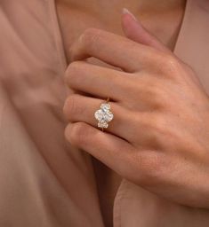 a woman's hand with a diamond ring on it