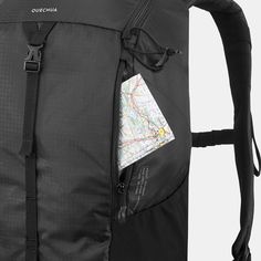 a black backpack with a map on the front pocket and zippers down the side