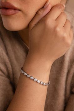 For the summer, diamonds are a great way to accessorize, and we have the perfect recommendation for the silver girlies! This diamond pear bracelet in silver is a cool twist to a regular diamond tennis bracelet. The unique pear shape adds a vintage elegance to this bracelet. Elegant Sparkling Diamond Bracelet As Gift, Elegant Sparkling Diamond Bracelet For Anniversary, Elegant Diamond Bracelet With Sparkling Stones As Gift, Elegant Sparkling Bracelets For Anniversary, Sparkling Fine Jewelry Bracelets For Wedding, Classic Sparkling Bracelet As A Gift, Classic Sparkling Bracelet Perfect As A Gift, Classic Sparkling Bracelets Perfect For Gifts, Classic Sparkling Bracelet For Gift