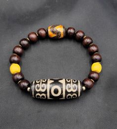 Ancient Old Dzi Tibetan Agate Stone And Brown Wood Beads Baraclet Adjustable Its Beautiful Quality Barclet Traditional Brown Beaded Bracelets With Natural Stones, Traditional Brown Beaded Bracelet With Natural Stones, Traditional Beaded Bracelets With Natural Stones For Healing, Spiritual Beaded Bangle Bracelet With Large Beads, Traditional Bracelets With Round Natural Stones, Traditional Bracelets With Natural Stones And Round Beads, Yellow Wooden Beads Bracelet, Spiritual Agate Jewelry With Wooden Beads, Yellow Wooden Bead Bracelets