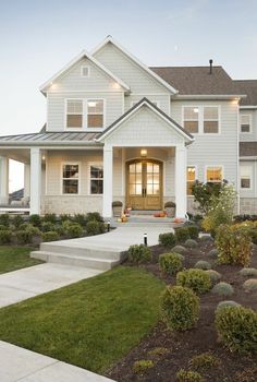 a white house with landscaping around it