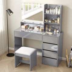 a dressing table with drawers, stool and mirror