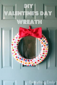 a valentine's day wreath hanging on the front door