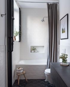 a white bathroom with a black and white checkerboard pattern on the floor is featured in this post