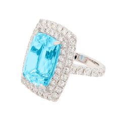 an aqua and white gold ring with diamonds on the sides, set in 18k white gold