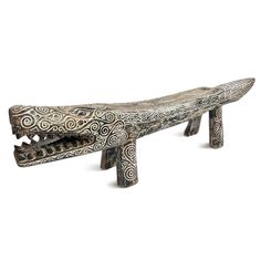 a wooden bench with intricate carvings on it