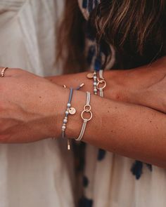 Introducing our new Sisters shareable hair tie & bracelet set. These are designed to celebrate the special connection between sisters! This beautiful set features dainty gold medal charms engraved with "Sis," along with delicate pearls, neutral colors, gold beads and interconnecting circles symbolizing the timeless bond you share. Whether worn as a hair tie or a bracelet, these accessories are fully adjustable to fit all sisters of every size and age. This darling set, perfect for gifting and sh Bracelets Sisters, Tie Bracelets, Hair Tie Bracelet, Boutique Homes, Gold Medal, Wristbands, Hat Band, Hair Tie, Gold Beads