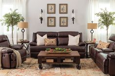 a living room filled with brown furniture and lots of pillows on top of the couches