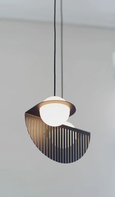 a light fixture hanging from the ceiling in a room with white walls and flooring