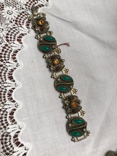 "Vintage bracelet with jeweled medallions Vintage bracelet with jeweled medallions.  1950's bracelet with 6 medallions with rhinestones pearls & green glass \"stones\". 7\" long. Good condition. Stones intact. $22" Ornate Green Bracelet Jewelry, Vintage Adjustable Bracelets With Jewels, Adjustable Vintage Bracelet Embellished, Adjustable Vintage Bracelet With Jewels, Vintage Decorative Bracelet Jewelry, Vintage Beaded Medallion Jewelry, Retro Green Bracelet Jewelry, Vintage Adjustable Charm Bracelet For Formal Occasions, Adjustable Vintage Charm Bracelet For Formal Occasions