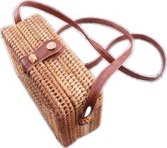 a brown wicker purse with leather straps