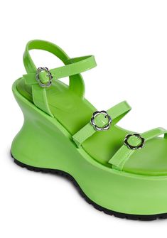 cuz time to be a tourist. These wedge sandals have a patent vegan leather construction, treaded soles, a strappy design, and adjustable daisy buckle closures. Spring Sandals With Adjustable Strap And Wedge Heel, Trendy Synthetic Wedge Sandals With Adjustable Strap, Green Platform Sandals With Ankle Strap, Green Wedge Sandals With Heel And Ankle Strap, Green Ankle Strap Platform Sandals, Spring Wedge Sandals With Adjustable Strap, Green Sandals With Adjustable Strap, Green Wedge Sandals With Heel Strap And Round Toe, Green Summer Wedge Sandals With Ankle Strap