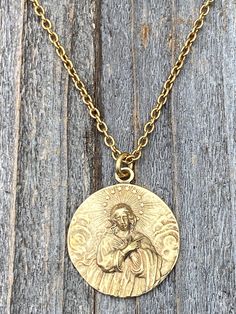 This is a solid gold bronze antique replica of a very rare Assumption of Mary medal from France. I am blessed to own this original and be able to share with you. The photographs do not capture the true beauty of this piece of art. Amazing depth and details! The oxidation and antiquing process highlights the gorgeous details. If you rub your fingers over the medal, Our Lady's face and body are very pronounced. The antique gold 2x3mm cable chain is 20 inches long and the medal is 1 inch round. A l Assumption Of Mary, Cross Medal, Opening An Etsy Shop, Lady Of Lourdes, Our Lady Of Lourdes, I Am Blessed, Medallion Necklace, Miraculous Medal, French Antique