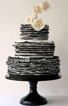 a black and white cake with flowers on top