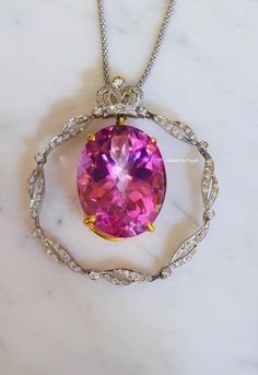 Metal: 14kt White And Yellow Gold Stone: Diamond And Pink Topaz Shape: Oval Pink Topaz And Round Diamonds Pink Topaz Weight: 63.90 ctw Diamond Weight: .87 ctw Weight of entire piece with chain: 28.80 grams Length Of Pendant From Top To Bottom: 54.03mm Width Of Pendant: 49.43mm Type of chain: 14kt White Gold Popcorn Chain. 1.70mm wide. Type of Lock: Lobster Clasp Type of Bail: Slide Through Length of chain: 16 Inch Note: Other chain styles and lengths available upon your request. Pendant can also Elegant Round Pink Sapphire Gemstones, Luxury Pink Jewelry Collectible, Luxury Pink Collectible Jewelry, Elegant Pink Sapphire Gemstones Gift, Dazzling Oval Pink Sapphire Jewelry, Luxury Pink Sapphire Round Jewelry, Gold Pink Sapphire Jewelry With Center Stone, Oval Fine Jewelry Necklace For Collectors, Fine Jewelry Oval Necklace For Collectors