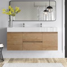 a bathroom vanity with two sinks and a large mirror