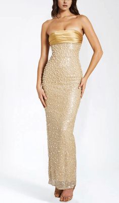 This stunning gold satin maxi dress is adorned with intricate sequins and delicate pearls, creating a truly luxurious and exclusive piece. Its flowing silhouette and exquisite detailing make it the perfect choice for any glamorous occasion. Elevate your wardrobe with this opulent dress. Materials: Sequin & Pearl Be Long Hoco Dresses Tight, Gold Formal Dresses Long, Gold Beaded Bridesmaid Dresses, Gold Sequin Maxi Dress, Pearl Maxi Dress, Dress With Pearls Detail, Gold Dresses Formal, Luxury Dress Glamour, Gold Formal Dresses