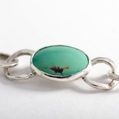 The "Laredo" Turquoise bracelet is handmade from 925 sterling silver (92.5% pure silver) in my workshop. It features a beautiful Natural Green Turquoise gemstone. Green Turquoise cabochon. Weight: 6.04 ct. Size: 19.75x16.01x2.51 mm Each link of the bracelet has been hand formed separately. Each link is soldered to the next one to form a finished bracelet. The whole bracelet is then polished by hand. The bracelet attaches with a handmade sterling silver hook clasp. Being hand formed, each link is Silver Turquoise Jewelry, Unique Bracelets, Hook Clasp, Green Turquoise, Turquoise Gemstone, Handmade Sterling Silver, Turquoise Sterling Silver, Pure Silver, Handmade Silver