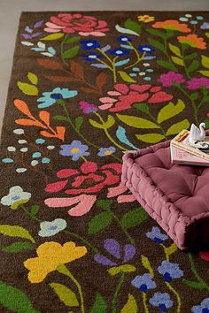 a brown rug with colorful flowers on it