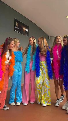 the girls are all dressed up in colorful outfits