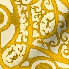 an intricately designed yellow and white wallpaper with swirly designs on the surface