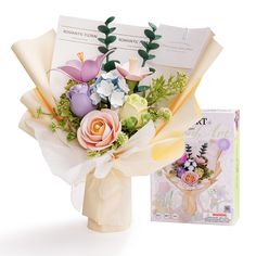 a bouquet of flowers in a vase next to a greeting card and brochure