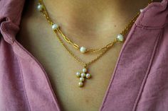 Timeless elegance abounds with this shell pearl cross necklace. This beautiful piece features a delicate pearl-encrusted cross charm on a dainty cable chain. It layers beautifully with other pieces, and also offers a dainty option when worn alone. A classic blend of pearls and cross creates a perfect symbol of faith and sophistication. A graceful look for special occasions and everyday. --Crafted from 18k gold-plated steel elements --Adjustable 16-18" length --Genuine shell pearls --Hypoallergen Gold Cross Necklace With Pearl Chain, Elegant Gold Cross Pearl Necklace, Elegant Cross-shaped Pearl Necklace For Gifts, Gold Cross-shaped Pearl Necklace, Spiritual Cross-shaped Pearl Necklace, Pearl Cross Necklace, Brunch Dress, Half Sleeve Dresses, Denim Shoes