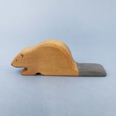 a small wooden animal on a white background