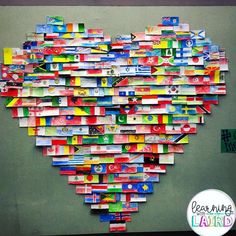 a heart made out of many different flags on a green wall with the words learning aids written below