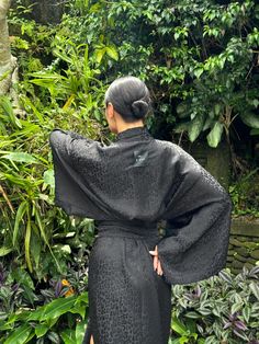 This black robe is a stunning Halloween black kimono gown, perfect for adding a touch of dark elegance to your wardrobe. Its loose and flowing design makes it an ideal gothic bathrobe for women, combining comfort with a dramatic flair. The robe features subtle, intricate patterns, reminiscent of a jacquard dress, adding texture and depth to its design. Inspired by traditional Japanese attire, it carries an animalistic Japanese robe aesthetic, blending unique cultural elements with a bold, contem Dark Kimono Aesthetic, Black Long Party Robe, Black Long Evening Robe, Long Black Evening Robe, Black Long Sleeve Kimono For Party, Black Long Kimono For Party, Long Black Party Kimono, Black Kimono With Kimono Sleeves For Party, Gothic Kimono